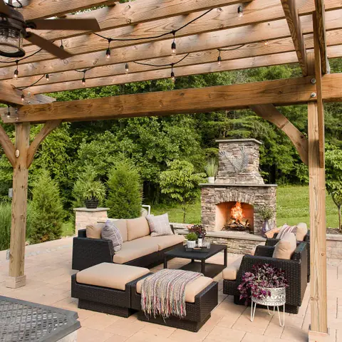 Paver patio with outdoor fireplace and pergola