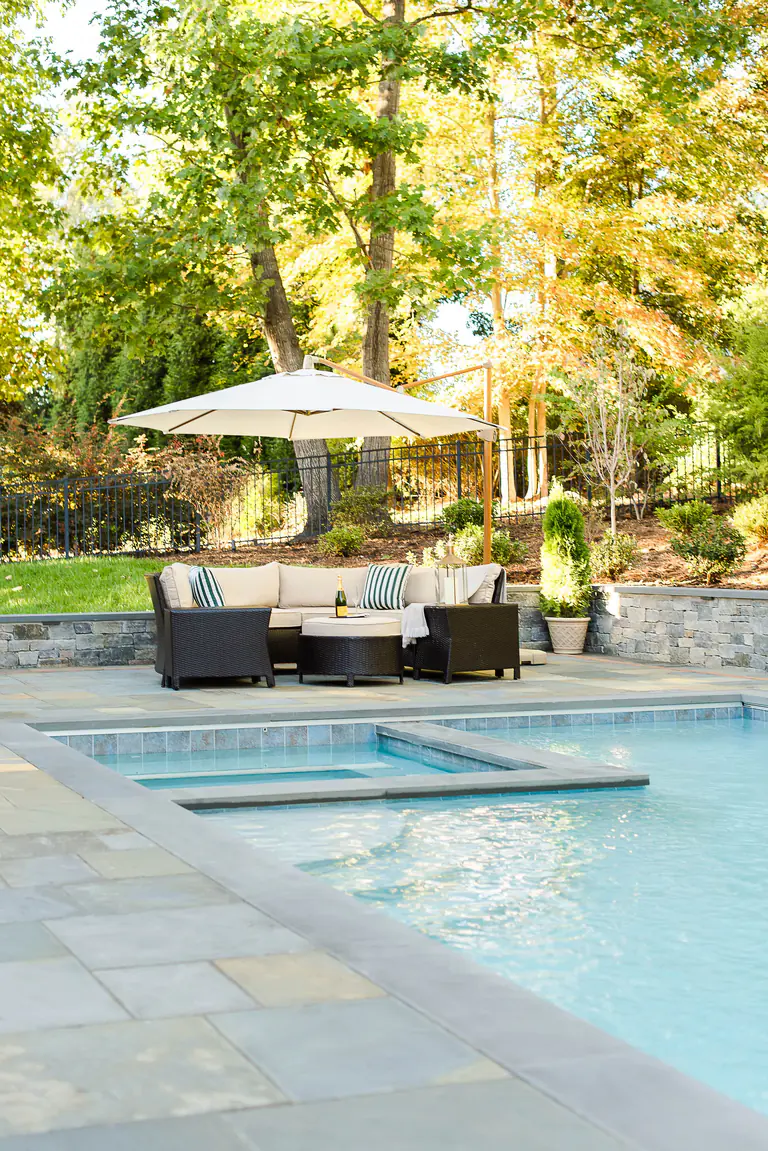 Stone patio fireplace with patio pavilion and paver patio