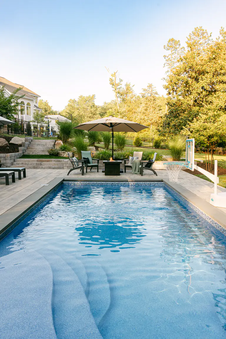 Gunite pool with hot tub and stone patio and pool decking
