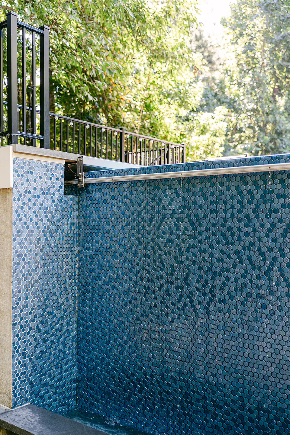 hidden automatic pool cover with Primera Stone in Sapphire Treasure finish