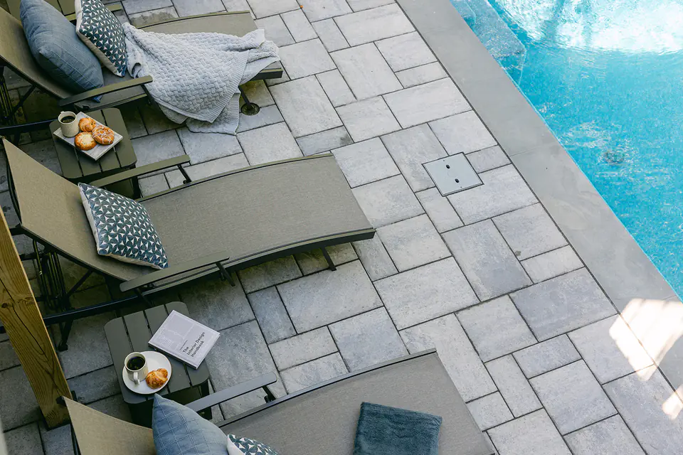 pool chairs on natural stone by pool